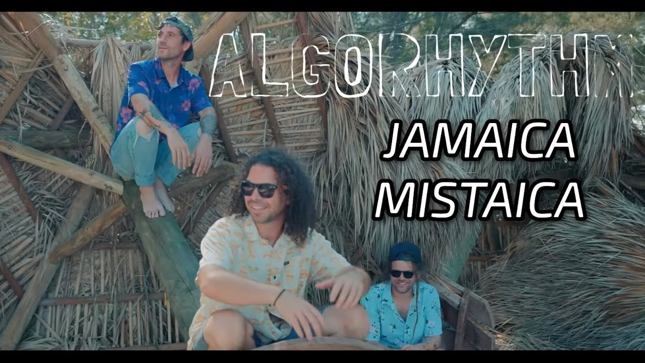 The band seated outdoors in the Algorhythm video for Jamaica Mistaica