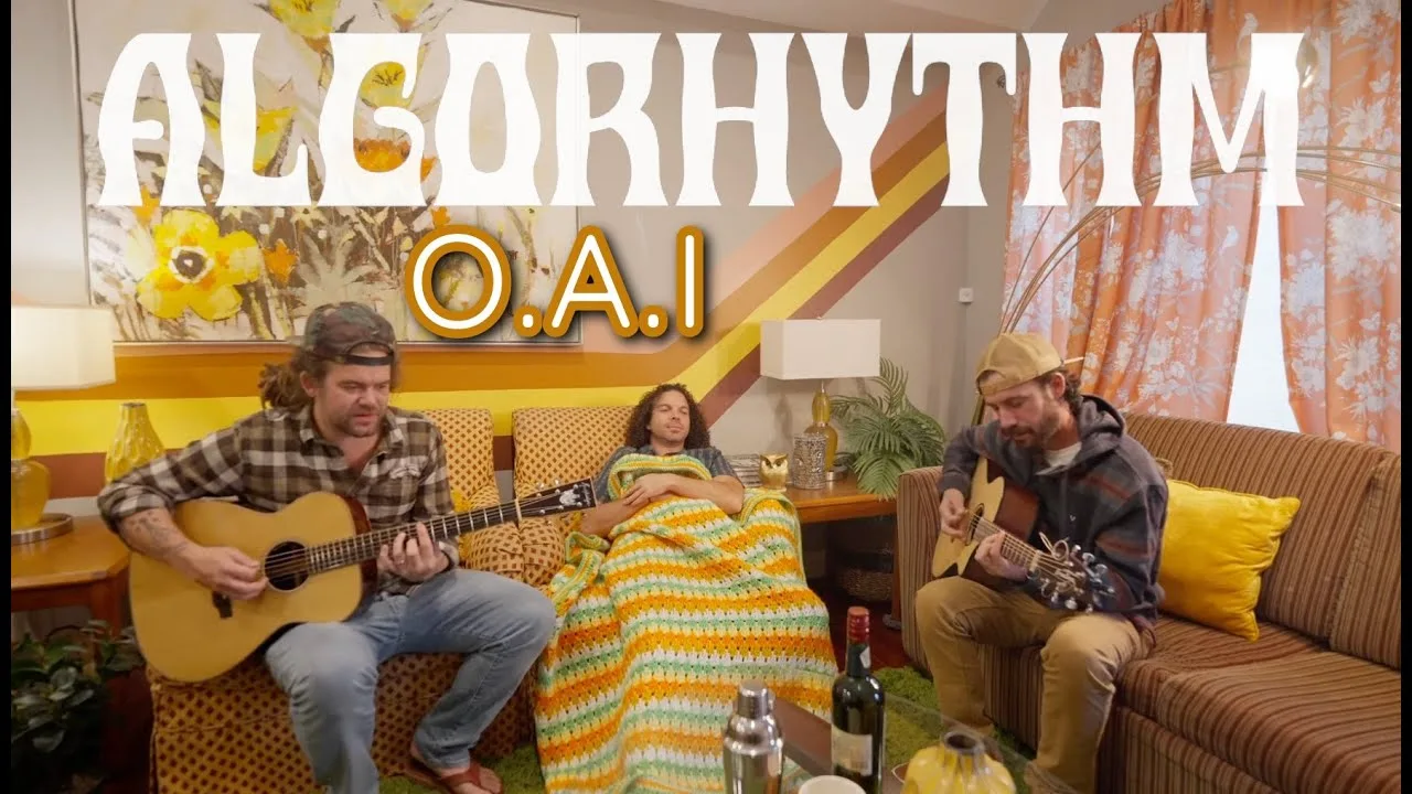 The band playing in a yellow living room in the Algorhythm video for O.A.I.